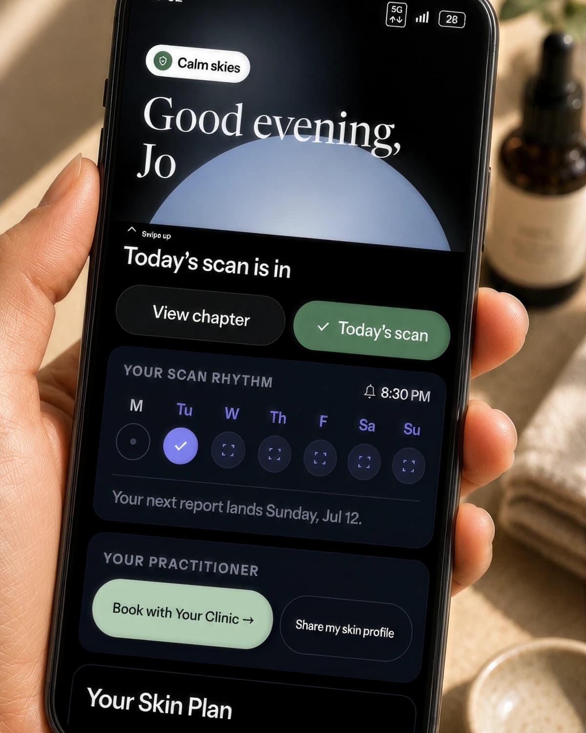 A close-up of the Stella app in a client's hand — their scan rhythm and practitioner card, with booking and profile sharing