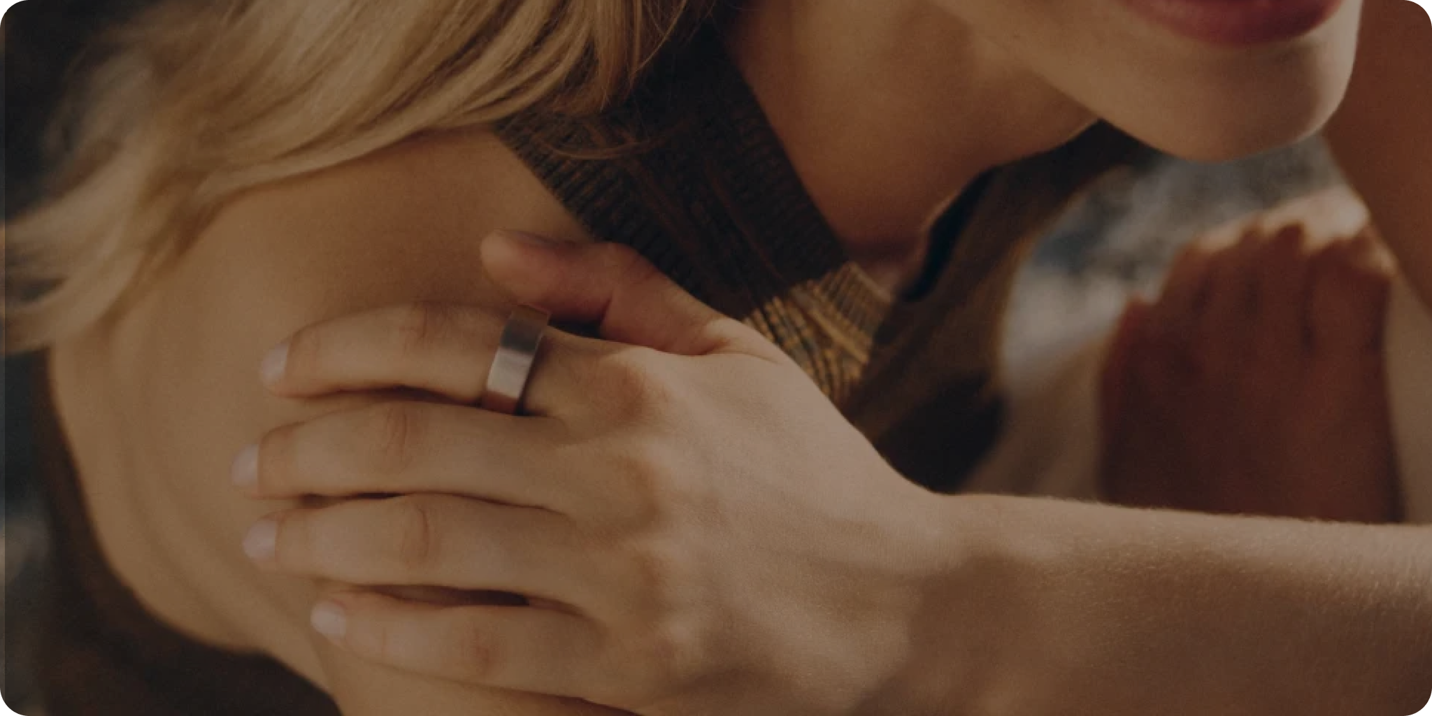 Close up of a woman with blonde hair wearing an Oura Ring.